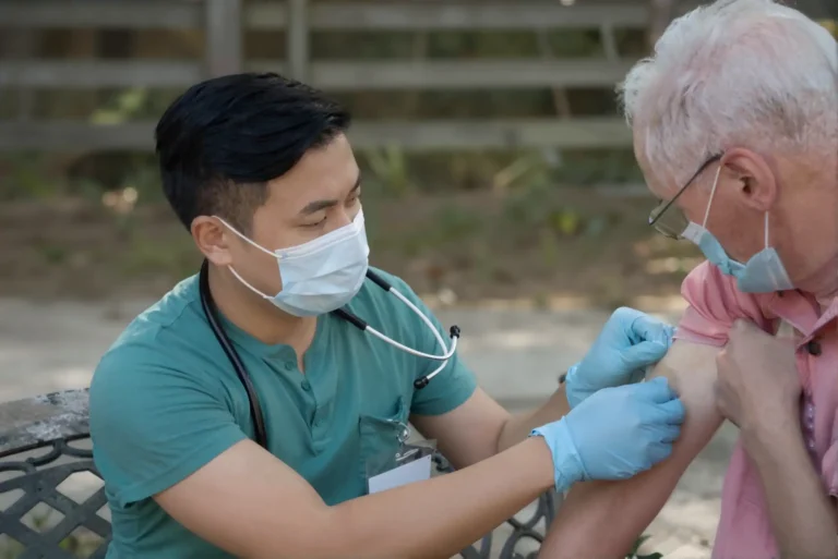 Medical professional vaccinating older patient